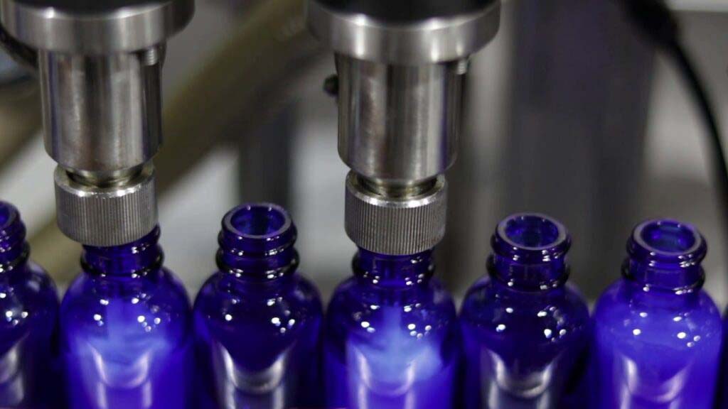Blue Liquid Glass Tincture Bottles being filled 